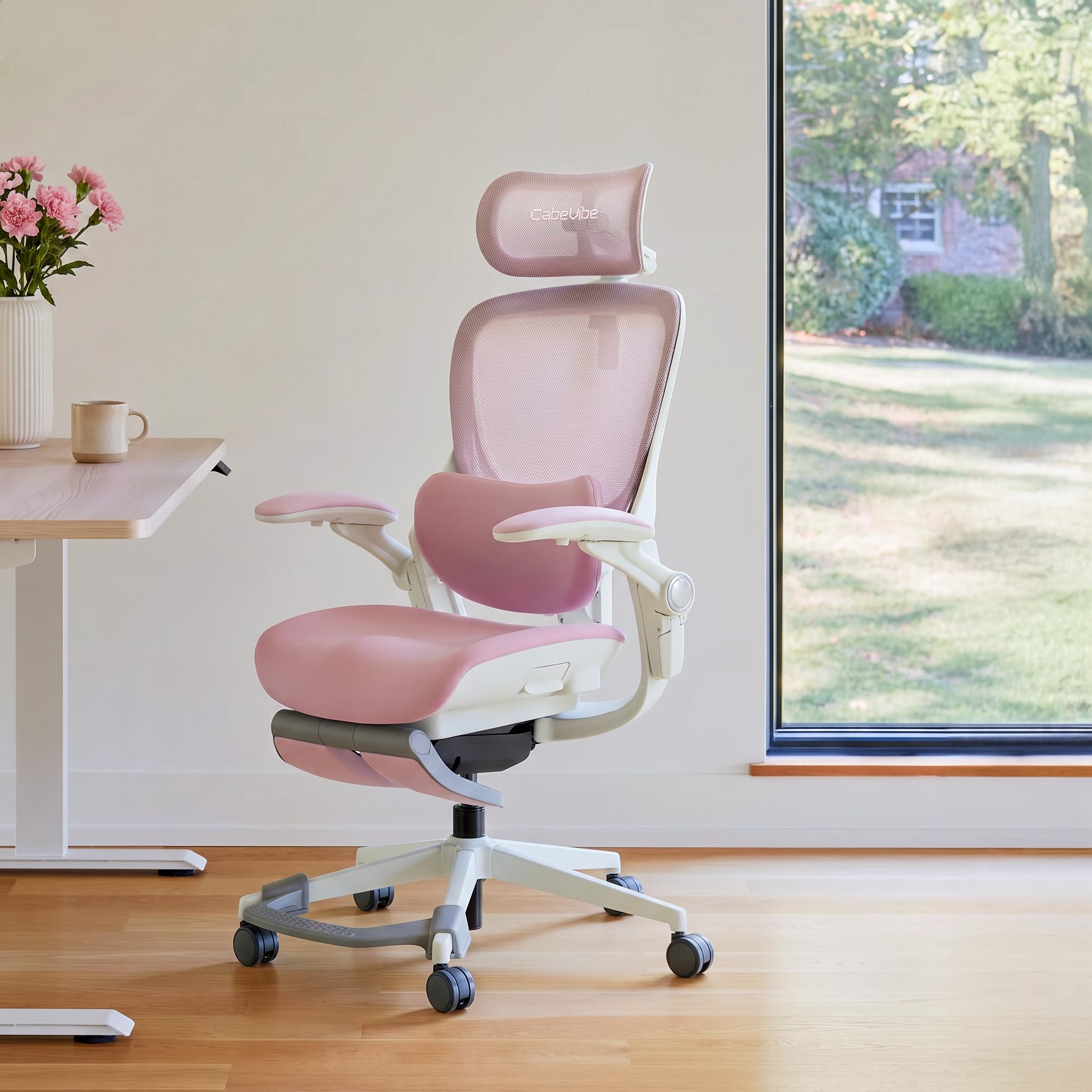 CabeVibe S2 pink ergonomic office chair in a bright home office with adjustable headrest and foot support bar