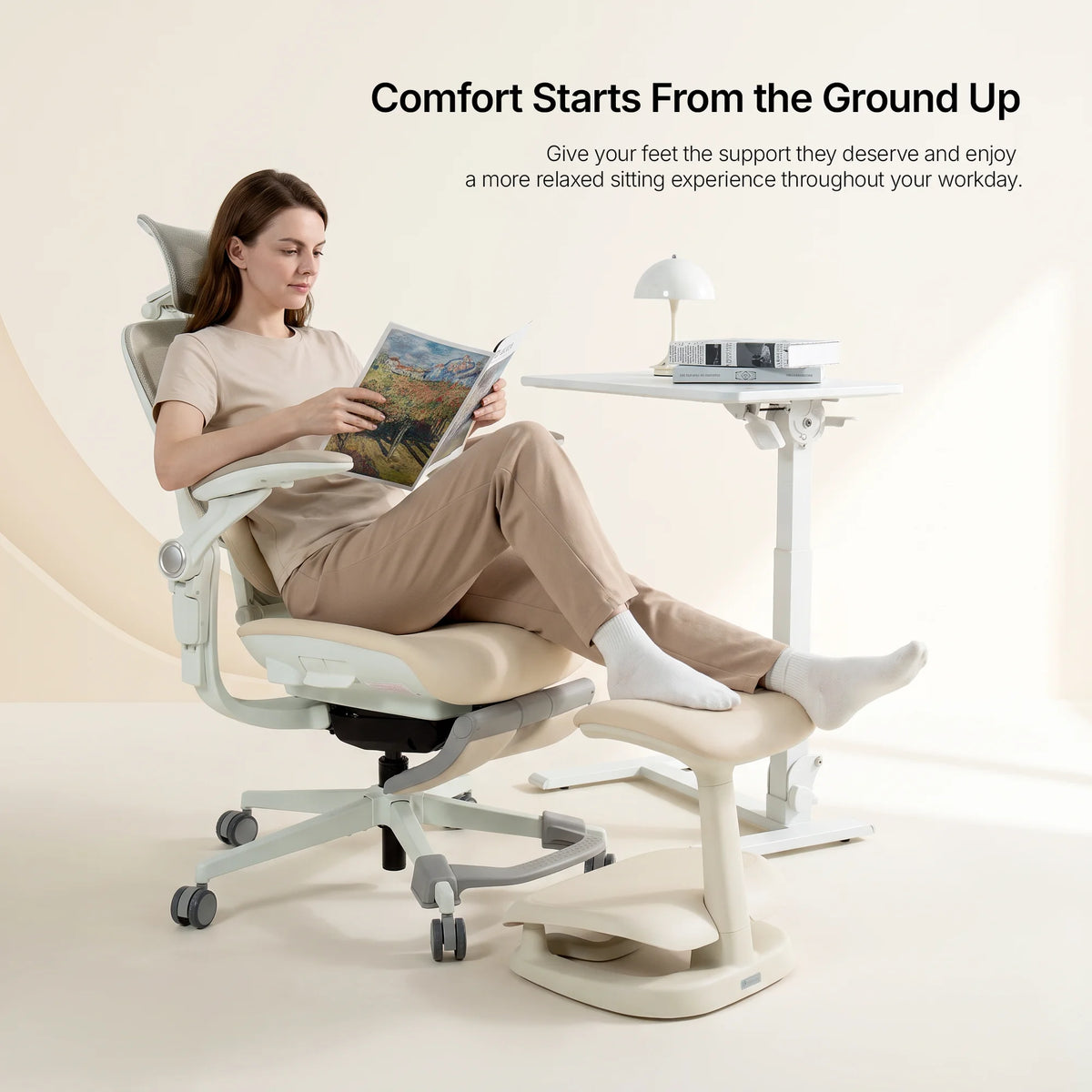 Woman reclining at her desk with feet resting on the cream Adjustable Under-Desk Footrest 