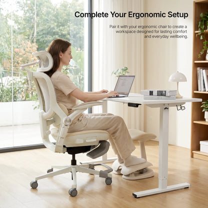 Home office setup pairing an ergonomic chair with the cream Adjustable Under-Desk Footrest 