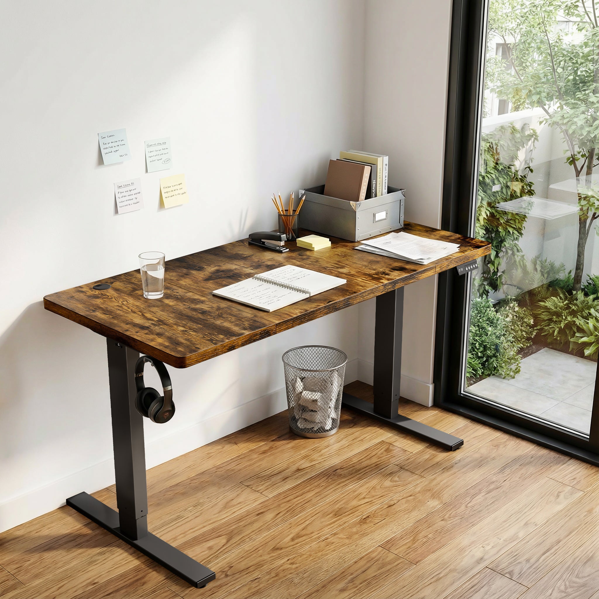 Brown CabDesk D60 height-adjustable standing desk in a home office workspace 